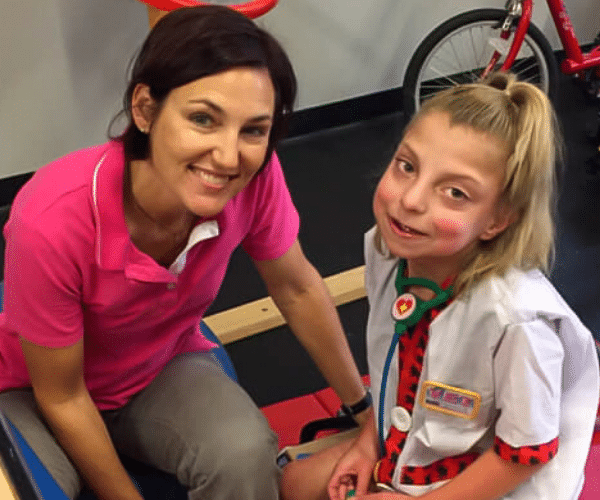 Lisa Davison, Physical Therapist and owner of Aspire Therapy Services, posing with a patient.