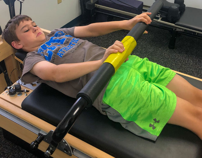 Boy on Pilates Reformer