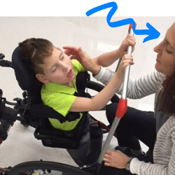 Lisa working with a severely disabled young boy in his wheelchair at yer Aspire Therapy Services physical therapy clinic in Cincinnati, OH located within May We Help on Wooster Pike.